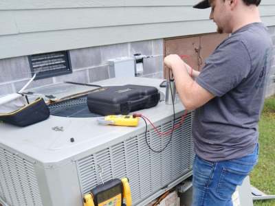 Engle Services HVAC Technician repairing an AC unit in Alabaster, Alabama